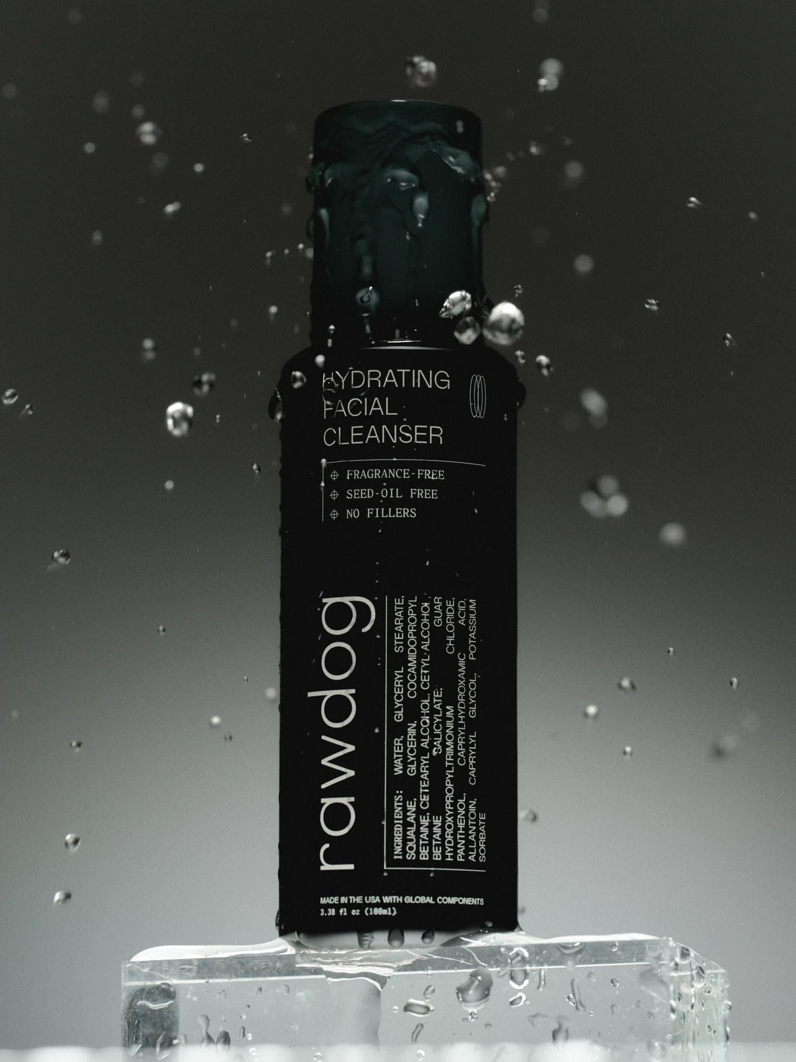 RAWDOG Hydrating Facial Cleanser bottle surrounded by water droplets