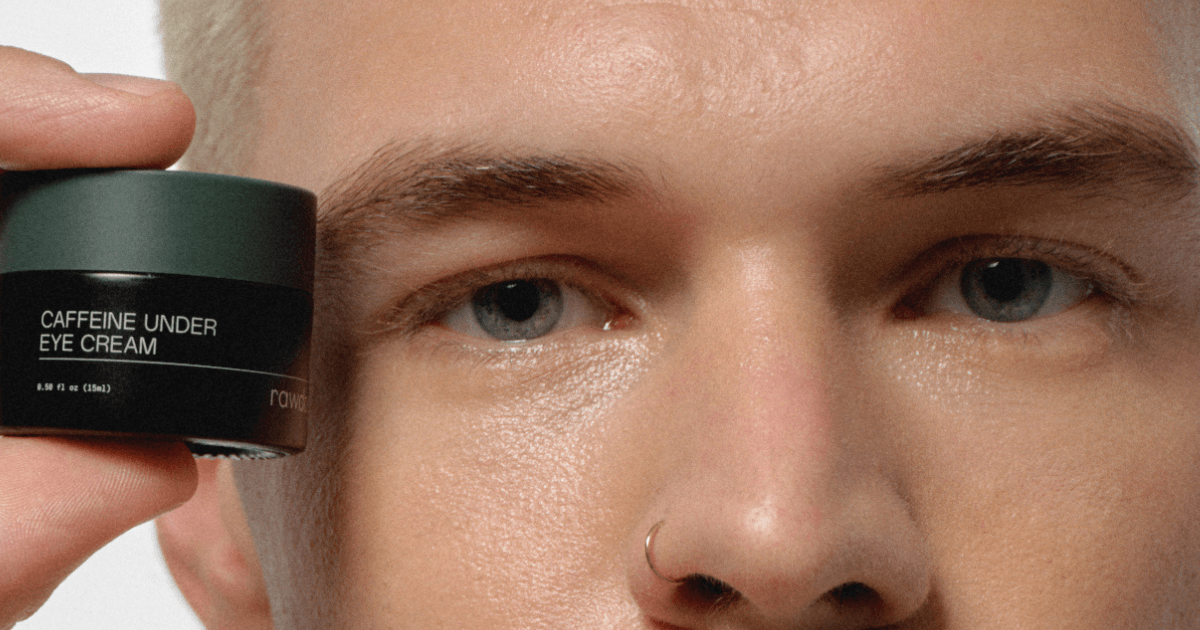 Man holding RAWDOG Caffeine Under Eye Cream beside his face